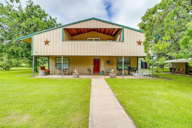 7203 Pump Station Rd, Jacksboro, TX 76458 - view of front of property featuring a patio area, a front yard, and board and batten siding