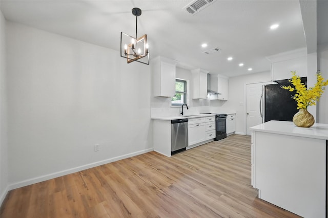 kitchen with dishwasher, electric range, wall chimney exhaust hood, visible vents, and freestanding refrigerator