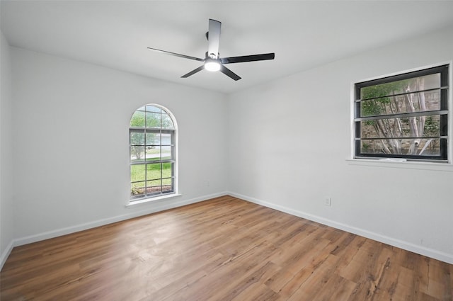 spare room featuring baseboards, a ceiling fan, and wood finished floors