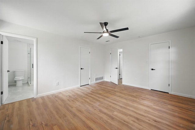 unfurnished bedroom with light wood-style floors, visible vents, and baseboards