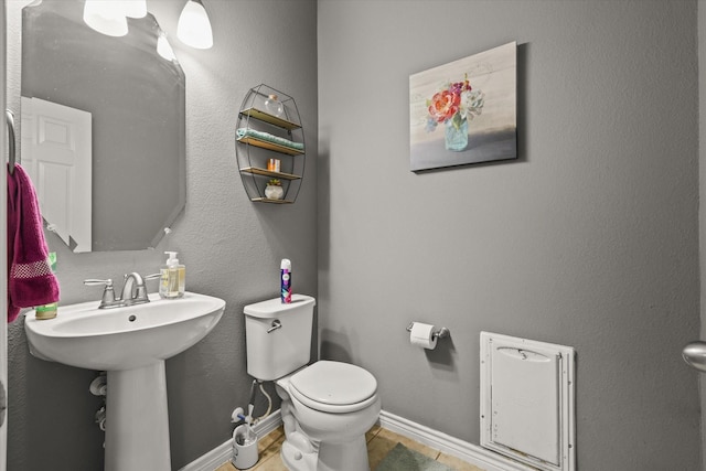 6521 Fitzgerald St, Fort Worth, TX 76179 - half bath featuring baseboards, a sink, and toilet