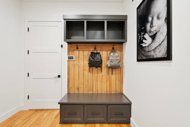 mudroom featuring baseboards and wood finished floors