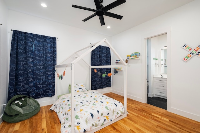 bedroom with recessed lighting, wood finished floors, baseboards, and connected bathroom