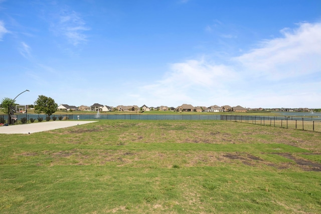 view of yard featuring fence and a residential view