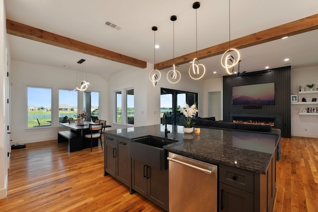 kitchen with stainless steel dishwasher, light wood-style flooring, visible vents, recessed lighting, and beamed ceiling