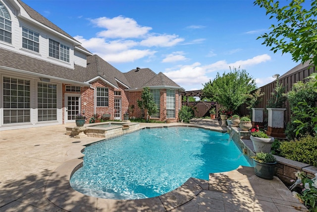 view of pool featuring an in ground hot tub, a fenced in pool, a fenced backyard, and a patio area