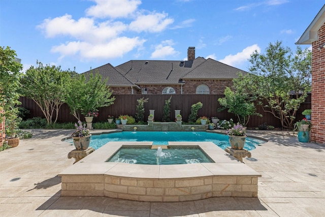view of swimming pool with a fenced backyard, a fenced in pool, a patio, and an in ground hot tub