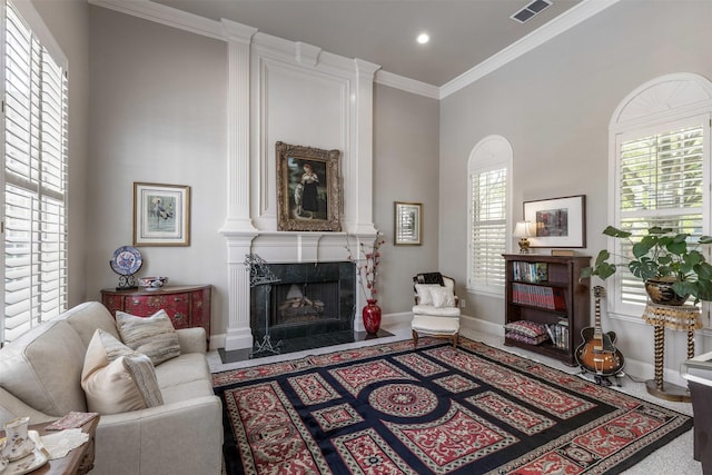 living room featuring visible vents, crown molding, baseboards, recessed lighting, and a premium fireplace