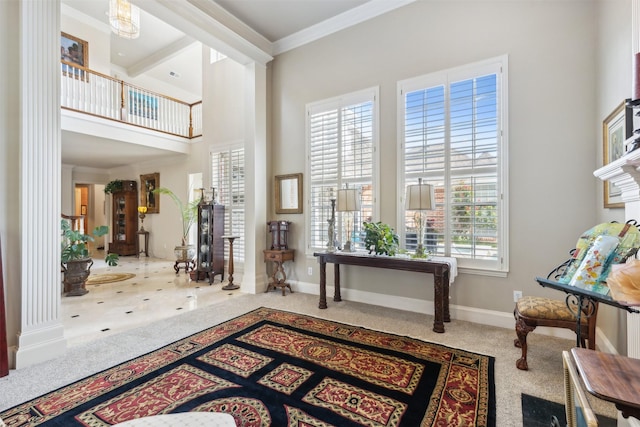 carpeted entrance foyer featuring crown molding, a high ceiling, and baseboards