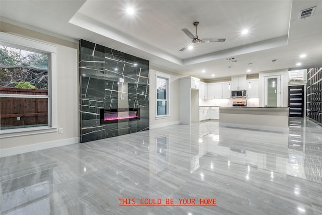 1963 Dennison St, Dallas, TX 75212 - living area with a tray ceiling, baseboards, a ceiling fan, recessed lighting, and a fireplace