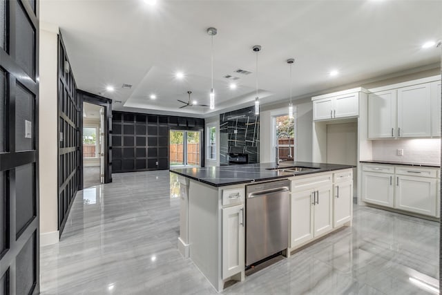 1963 Dennison St, Dallas, TX 75212 - kitchen featuring stainless steel dishwasher, dark countertops, a sink, a raised ceiling, and white cabinets