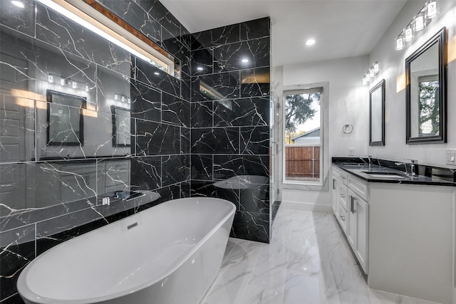 1963 Dennison St, Dallas, TX 75212 - full bath featuring a freestanding bath, double vanity, recessed lighting, marble tiled floors, and tile walls