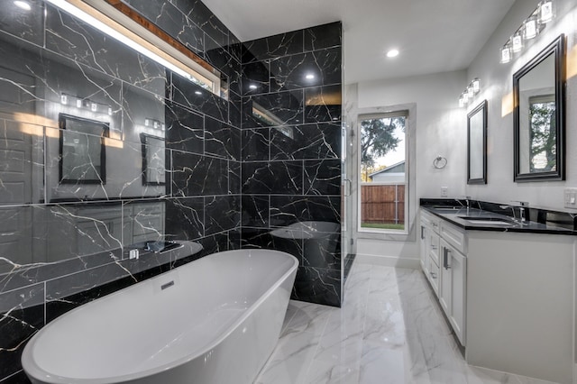 1963 Dennison St, Dallas, TX 75212 - full bathroom with a freestanding bath, double vanity, marble tiled flooring, tile walls, and recessed lighting