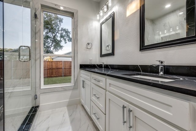 1963 Dennison St, Dallas, TX 75212 - bathroom with marble finish flooring, double vanity, a stall shower, baseboards, and a textured wall