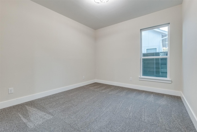 1963 Dennison St, Dallas, TX 75212 - spare room featuring dark colored carpet and baseboards