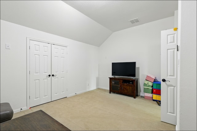 game room with light colored carpet, vaulted ceiling, visible vents, and baseboards