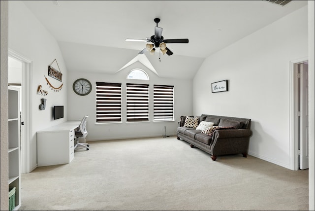 office space with ceiling fan, light carpet, vaulted ceiling, and baseboards