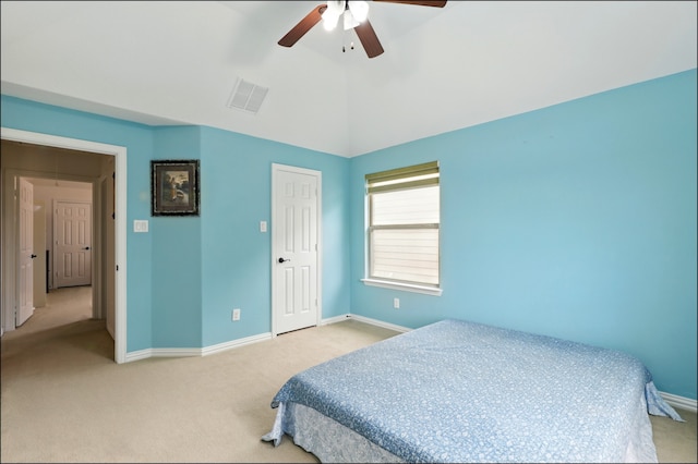 bedroom featuring baseboards, visible vents, light colored carpet, and ceiling fan
