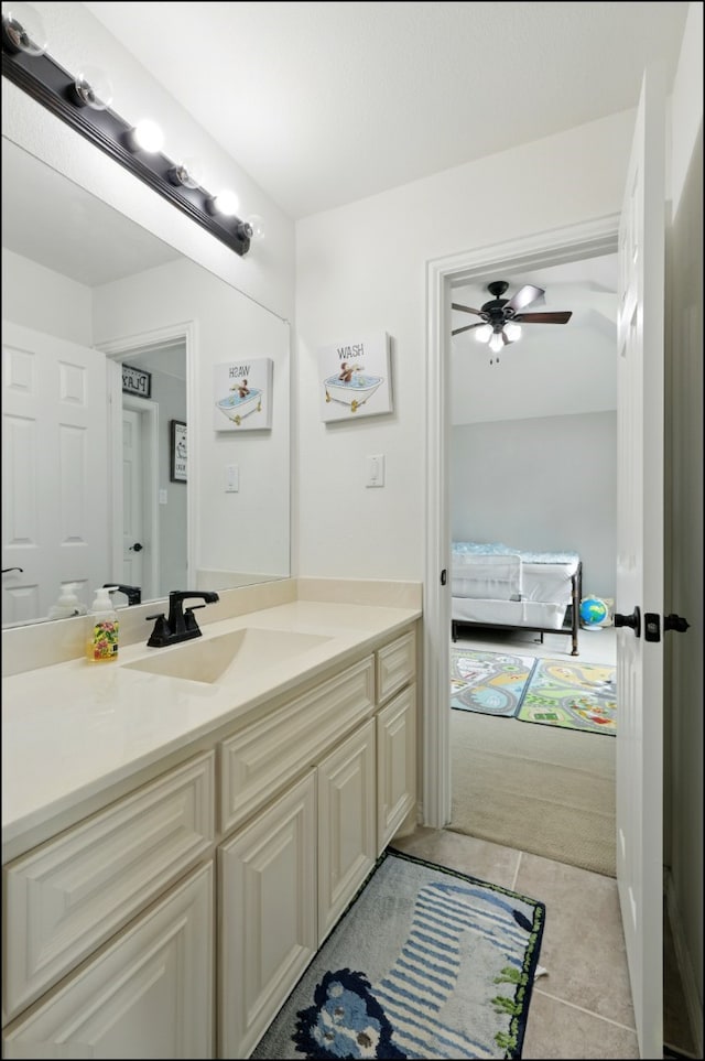 bathroom with tile patterned flooring, a ceiling fan, and vanity