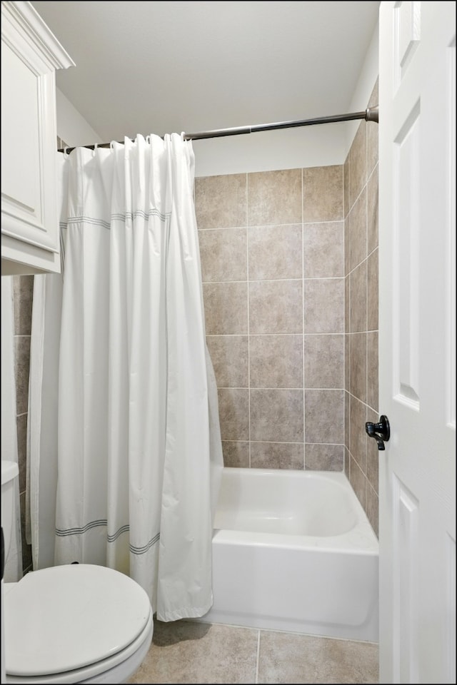 full bath featuring shower / tub combo, tile patterned floors, and toilet