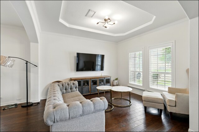 living area featuring dark wood finished floors, a raised ceiling, arched walkways, and crown molding