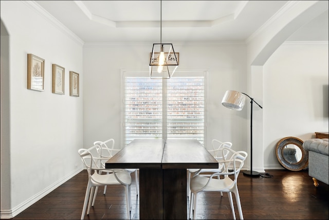 dining room featuring baseboards, dark wood-style flooring, and a tray ceiling