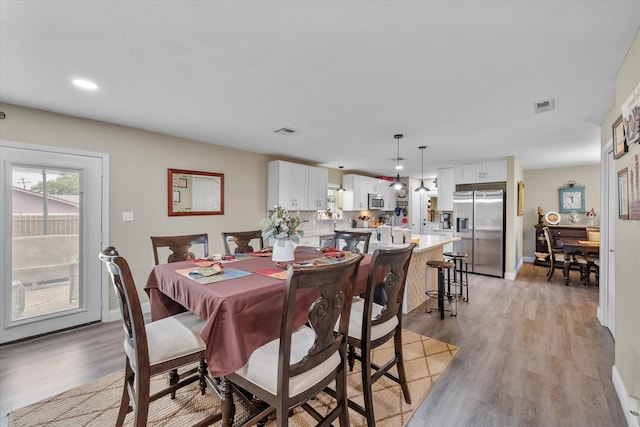 1410 Hummingbird Dr, Hillsboro, TX 76645 - dining room with recessed lighting, visible vents, light wood-style flooring, and baseboards