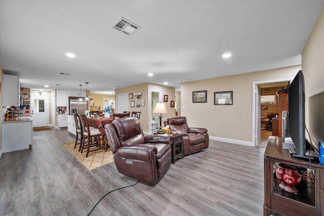 1410 Hummingbird Dr, Hillsboro, TX 76645 - living area with recessed lighting, visible vents, and wood finished floors