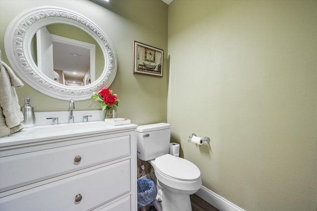 1410 Hummingbird Dr, Hillsboro, TX 76645 - half bathroom with baseboards, toilet, and vanity