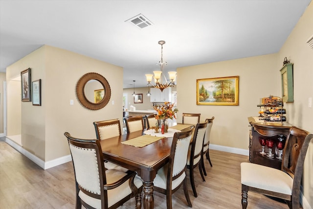 1410 Hummingbird Dr, Hillsboro, TX 76645 - dining space featuring visible vents, baseboards, a chandelier, and light wood-style floors