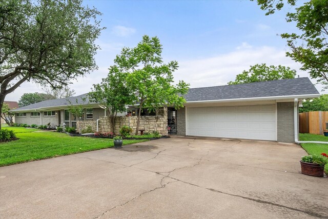 1410 Hummingbird Dr, Hillsboro, TX 76645 - single story home with brick siding, fence, driveway, a front lawn, and an attached garage