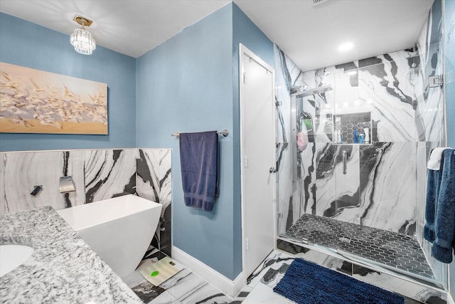 1410 Hummingbird Dr, Hillsboro, TX 76645 - full bath with a soaking tub, baseboards, marble finish floor, and a marble finish shower