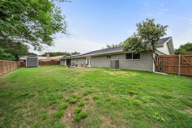 1410 Hummingbird Dr, Hillsboro, TX 76645 - view of yard featuring an outbuilding, a storage shed, central air condition unit, and a fenced backyard