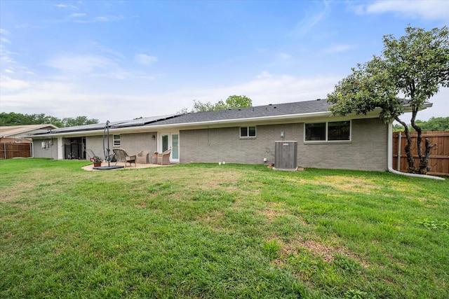 1410 Hummingbird Dr, Hillsboro, TX 76645 - rear view of property featuring a lawn, a patio area, a fenced backyard, and central AC unit