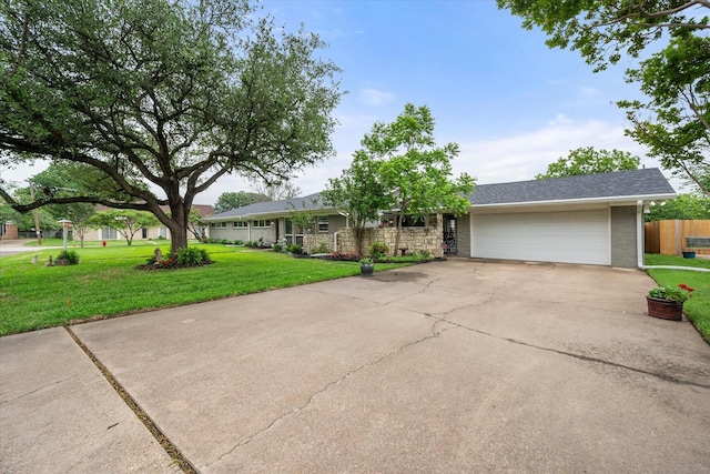 1410 Hummingbird Dr, Hillsboro, TX 76645 - single story home with a front yard, brick siding, concrete driveway, an attached garage, and fence