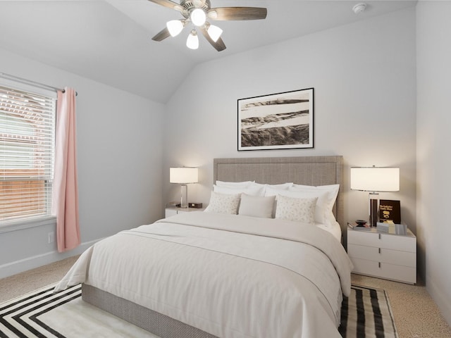 bedroom featuring carpet, multiple windows, and lofted ceiling