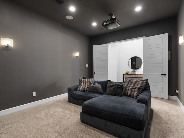 home theater room with baseboards, recessed lighting, and light carpet