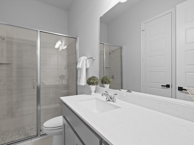 full bath featuring vanity, toilet, and a stall shower