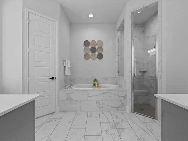 bathroom featuring recessed lighting, marble finish floor, vanity, a marble finish shower, and a garden tub