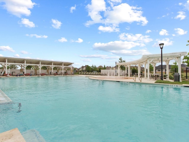 community pool featuring a patio and fence