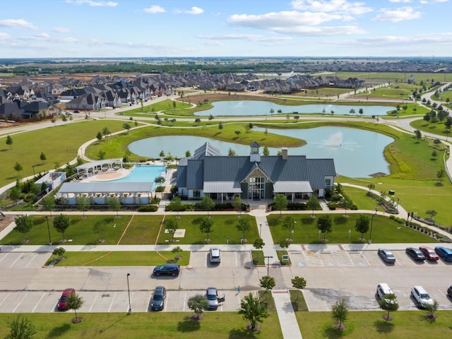 drone / aerial view featuring a residential view and a water view