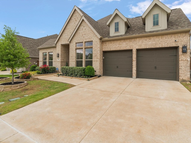 view of front of house with concrete driveway, a shingled roof, and brick siding