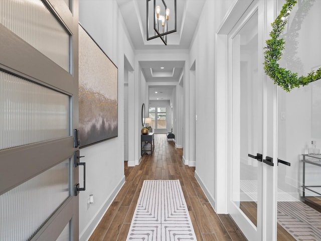 foyer entrance with dark wood-style floors, baseboards, an inviting chandelier, and recessed lighting