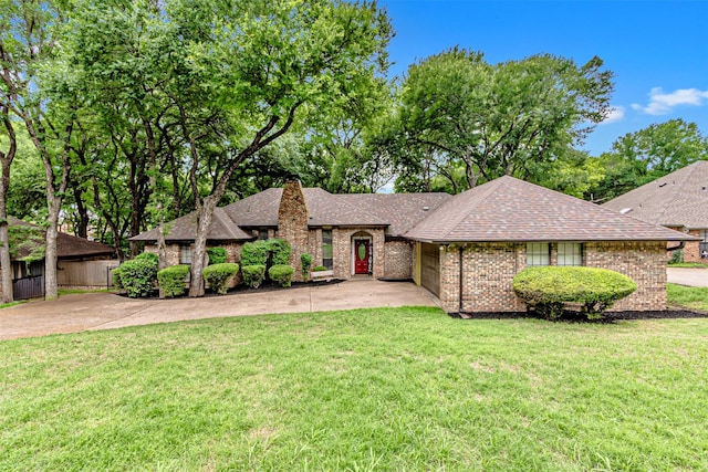 ranch-style house with a shingled roof, a chimney, a front lawn, and a garage
