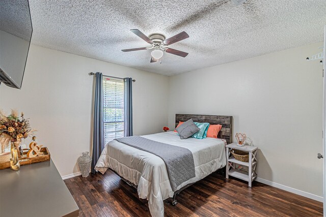 bedroom featuring baseboards, a textured ceiling, and wood finished floors