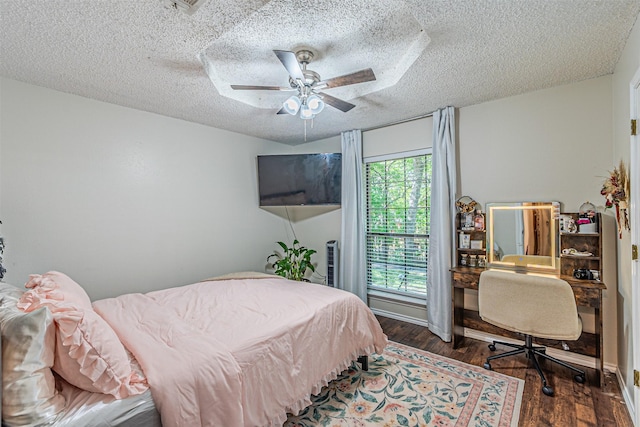 bedroom featuring a textured ceiling, ceiling fan, and wood finished floors