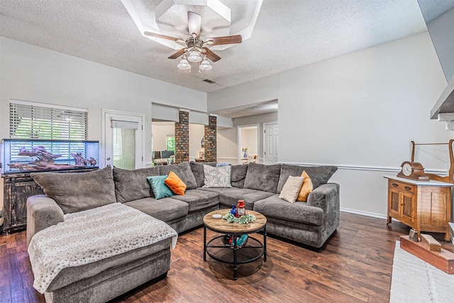 living room with a wealth of natural light, ceiling fan, a textured ceiling, and wood finished floors