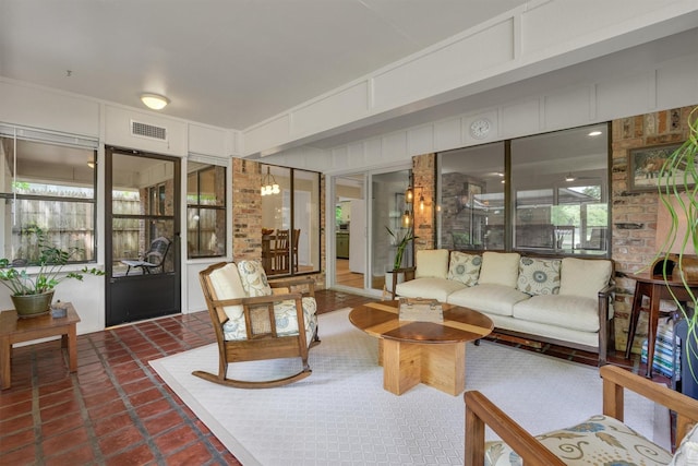 living area featuring dark tile patterned floors and visible vents