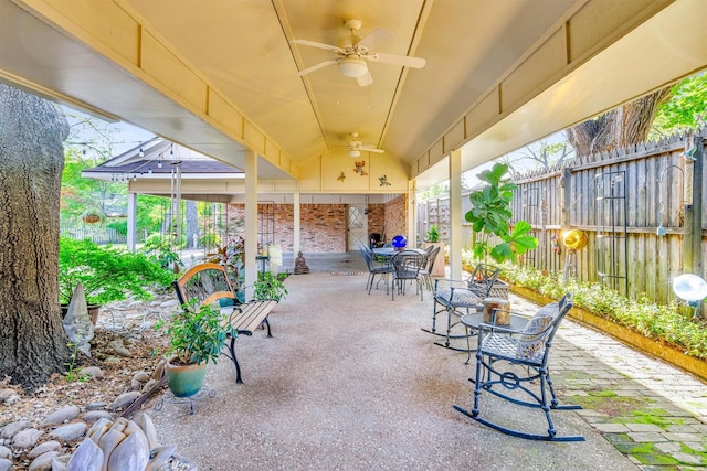 view of patio with fence, outdoor dining area, and ceiling fan