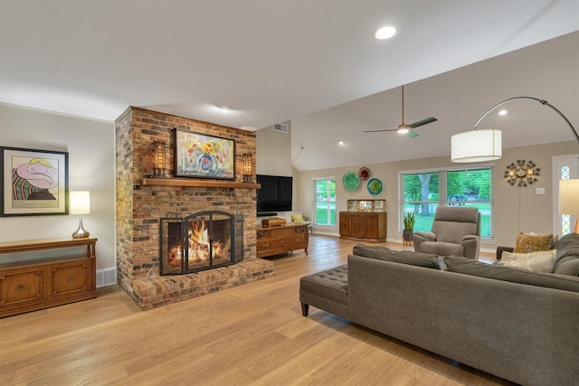 living room featuring a fireplace, light wood-style floors, a ceiling fan, recessed lighting, and visible vents